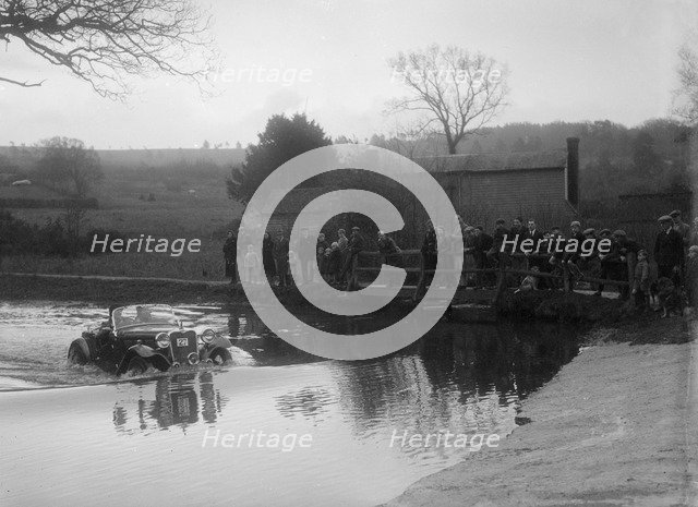 972 cc Singer Le Mans driving through a ford during a motoring trial, 1936. Artist: Bill Brunell.