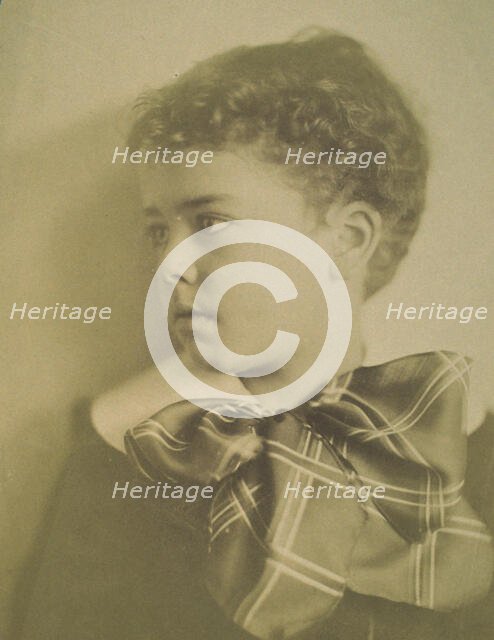 Head-and-shoulders portrait of a young boy with a large plaid bow at the neck of his..., c1900. Creator: Horace L Bundy.