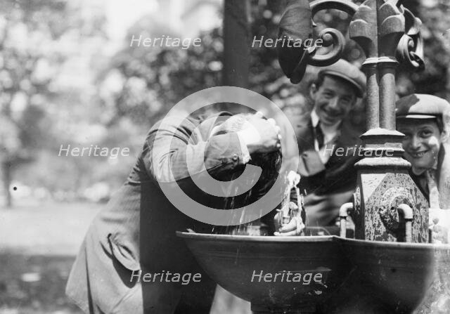 Cooling his head - N.Y. on hot day, between c1910 and c1915. Creator: Bain News Service.