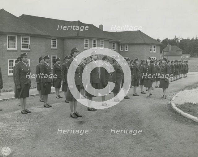 Army nurses standing at attention in front of their barracks and being inspected by..., 1939 - 1945. Creator: Unknown.