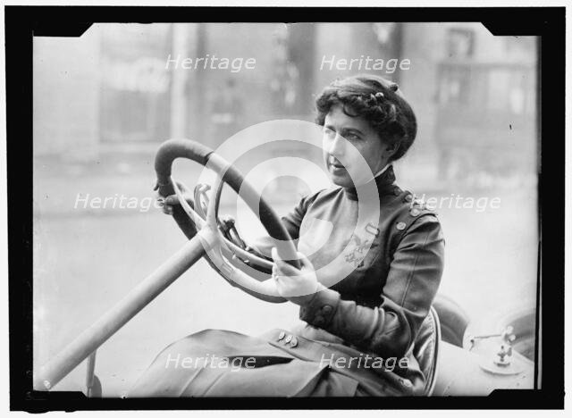Race car driver Joan Newton Cuneo, seated in racing car, facing left, between 1910 and 1917. Creator: Harris & Ewing.