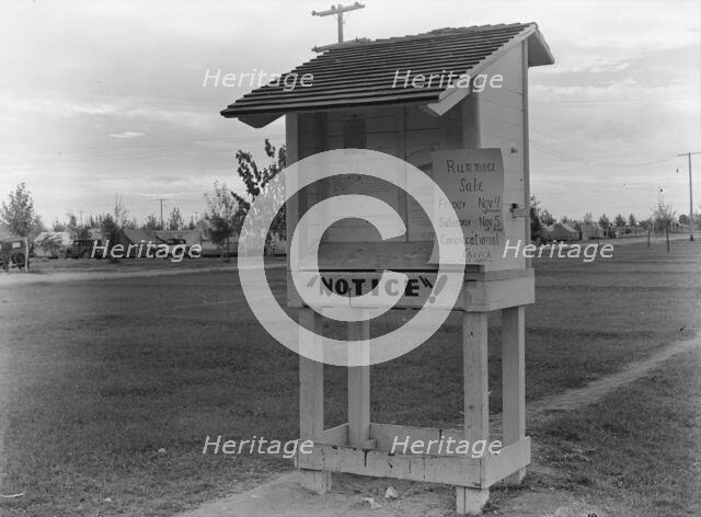 Campers' bulletin board near entrance of Shafter camp for migrant workers, California, 1938. Creator: Dorothea Lange.