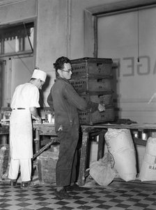 Delivery boy picking up bread  boxes at the Lisa Öhman Bakery, Stockholm, Sweden, 10th October 1942. Artist: Karl Sandels