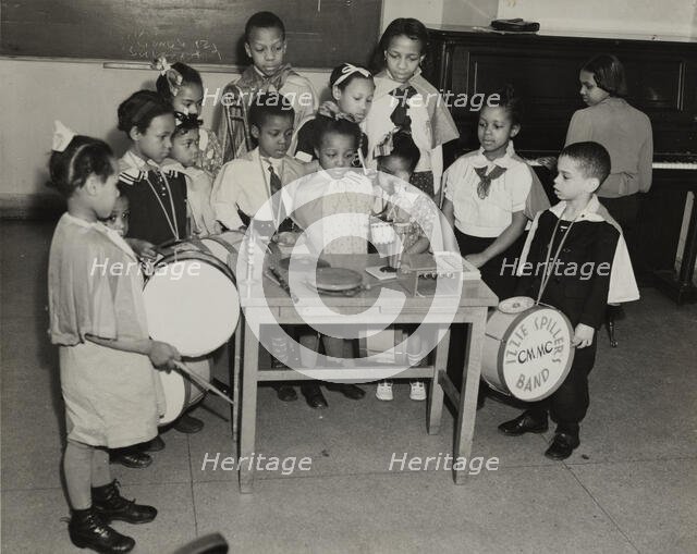 Drum students around a table, 1938. Creator: Andrew Herman.