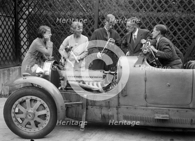 Denis Evans inspecting the plugs of his Bugatti Type 43 2262cc. Artist: Bill Brunell.