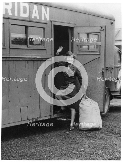 A WAAC boarding a bus, Fort Sheridan, Illinois, USA, 1940. Artist: Unknown