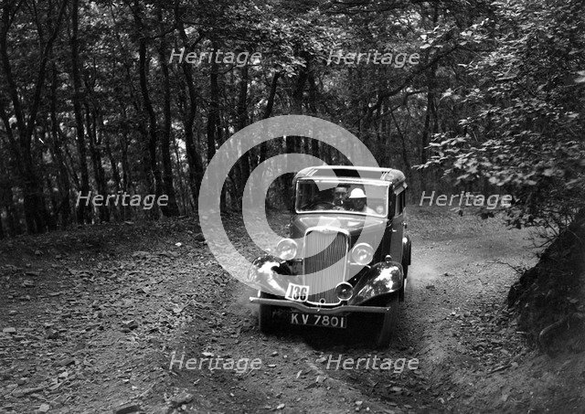 Singer Nine saloon competing in the B&HMC Brighton-Beer Trial, Fingle Bridge Hill, Devon, 1934. Artist: Bill Brunell.