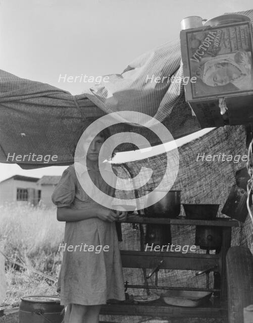 Migratory child in camp at end of day, Bean pickers' camp near West Stayton, Oregon , 1939. Creator: Dorothea Lange.