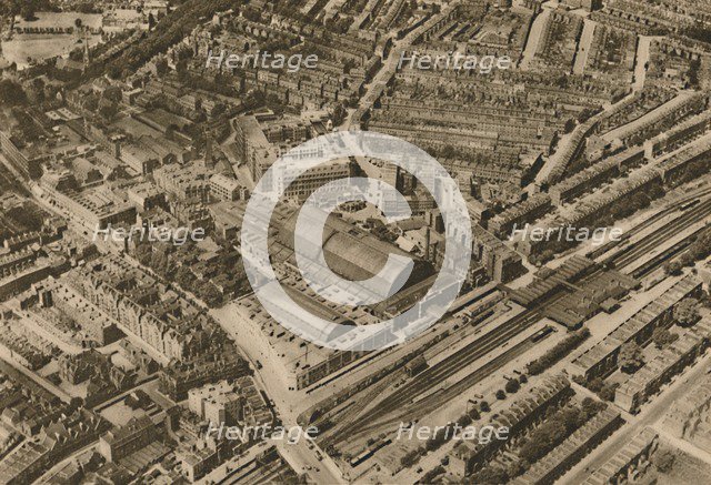 'Over Olympia and the Headquarters of the Post Office Savings Bank', c1935. Creator: Surrey Flying Services.