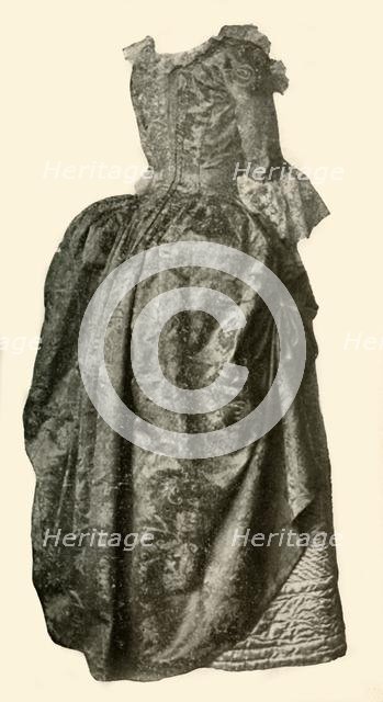 'Gown of yellow damask brocade worn over a blue quilted satin petticoat, c1710-1730, (1937). Creator: Unknown.