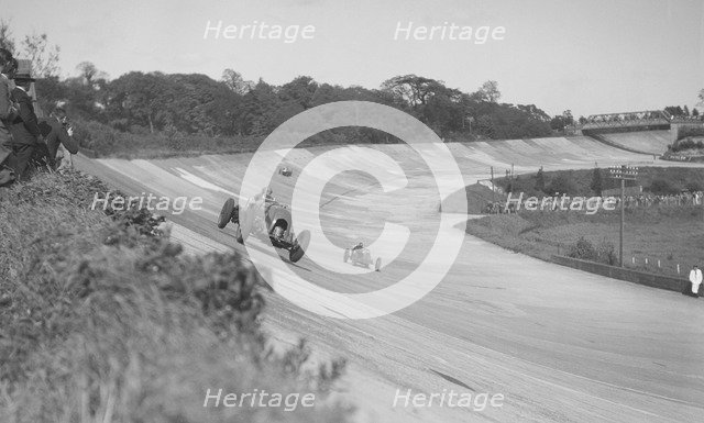 Sir Henry Birkin's Bentley leading Earl Howe's Bugatti Type 54, BARC meeting, Brooklands, May 1932. Artist: Bill Brunell.