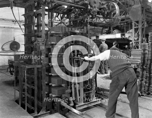 Loading a palletising machine with bricks, Whitwick Brickworks, Coalville, Leicestershire, 1963. Artist: Michael Walters