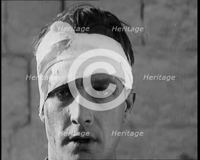 Scene from a Film: Male Actor Playing a Survivor from the Battle Being Questioned..., 1920s. Creator: British Pathe Ltd.