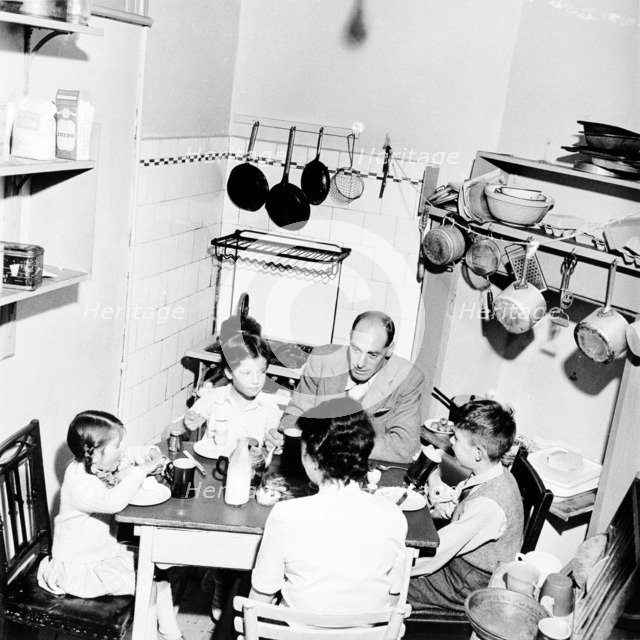 A family dining in their London home, c1950s. Artist: Henry Grant