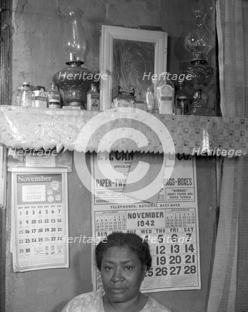 Negro woman in her home, Washington (southwest section), D.C., 1942. Creator: Gordon Parks.