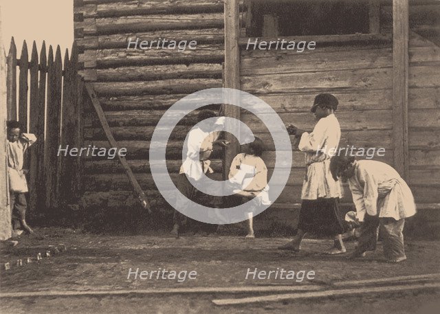 Boys playing Knucklebones, 1860s.