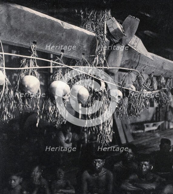 Sarawak: decorated human skulls hanging in a Kayan house, c1900. Creator: Unknown.