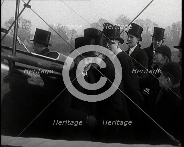 A Group of Young Male British Civilians Admiring an Airplane On an Airfield, 1920s. Creator: British Pathe Ltd.