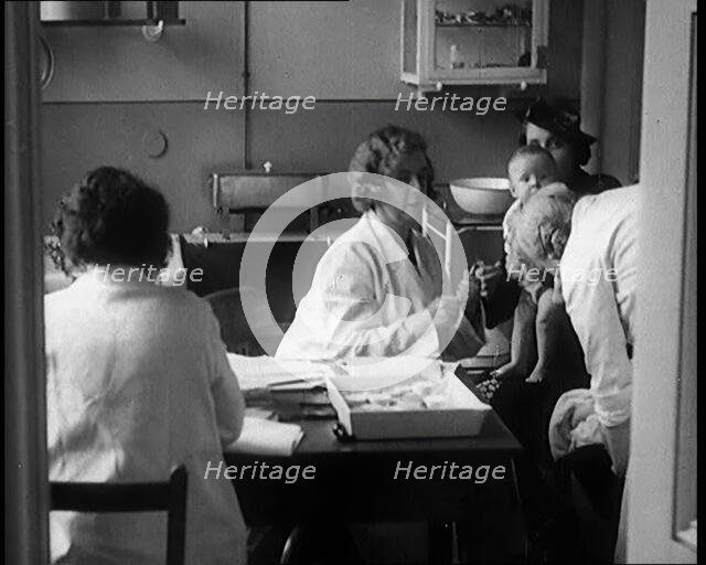Female Civilians and Their Babies at Health Clinics Where the Babies Are Checked by Female..., 1931. Creator: British Pathe Ltd.