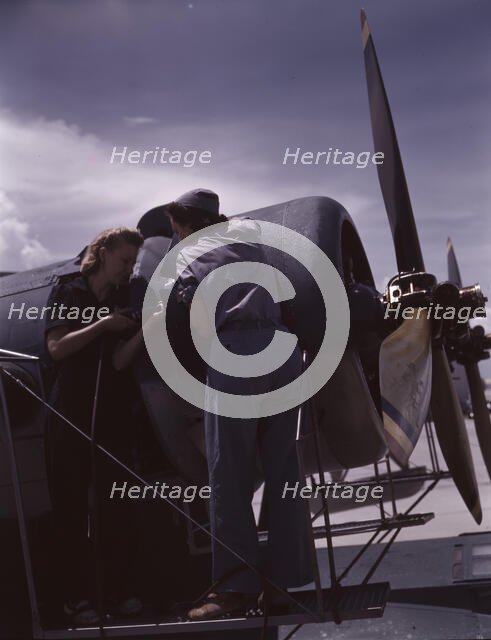 Bowen and Olsen, a riveter and her supervisor, in the...Naval Air Base, Corpus Christi, Texas, 1942. Creator: Howard Hollem.