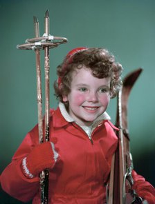 Young girl with cross-country ski equipment, c1955.  Creator: Arthur Charles Kirby Ware.