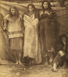 Group of Native Americans, three standing, one seated on the ground, possibly..., 1860 or 1861. Creator: Unknown.