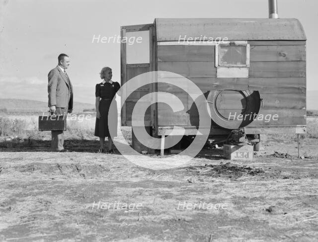 The camp nurse introduces doctor to mother of sick baby, Merrill, Klamath County, Oregon, 1939. Creator: Dorothea Lange.