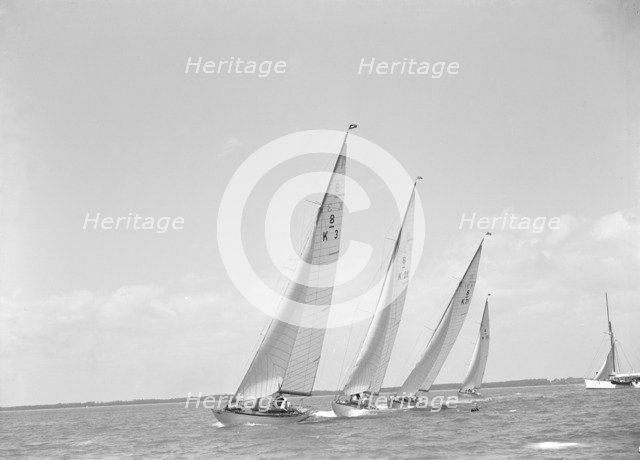 Group of 8 Metre sailing yachts racing close-hauled. Creator: Kirk & Sons of Cowes.
