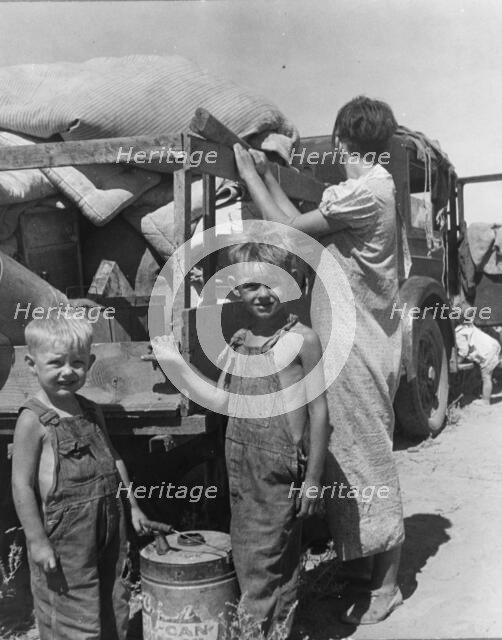 Part of an impoverished family of nine on a New Mexico highway, 1936. Creator: Dorothea Lange.