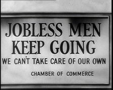 Sign reads: 'Jobless Men Keep Going - We Can Take Care of Our Own - Chamber of Commerce', 1932. Creator: British Pathe Ltd.