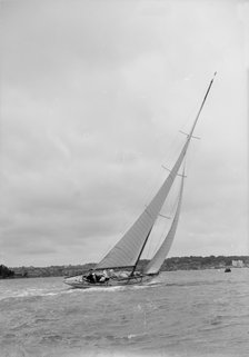12 Metre class sailing yacht heeling over in windy conditions on upwind leg, 1938. Creator: Kirk & Sons of Cowes.