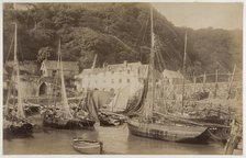 Fishing boats in the harbour at Clovelly, seen from the Pier, with the Red Lion Hotel..., c1885. Creator: James Valentine.