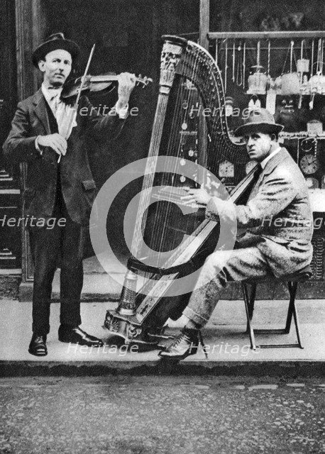 Street musicians, London, 1926-1927. Artist: Unknown