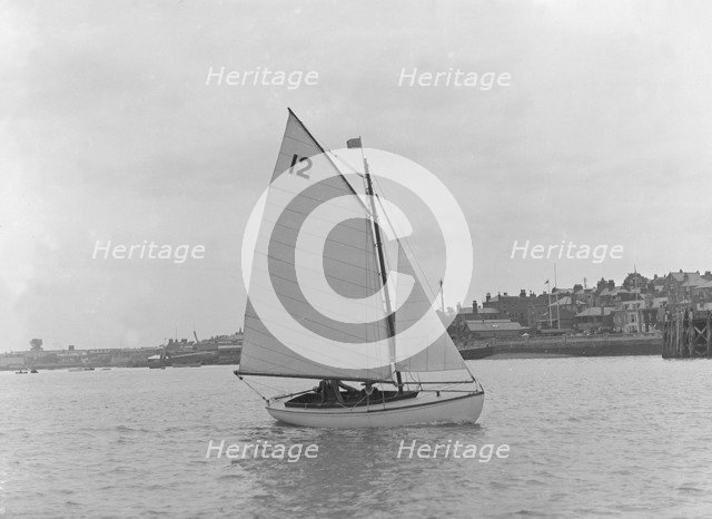 A Hamble River Class dinghy (No 12) sailing close-hauled, 1921. Creator: Kirk & Sons of Cowes.