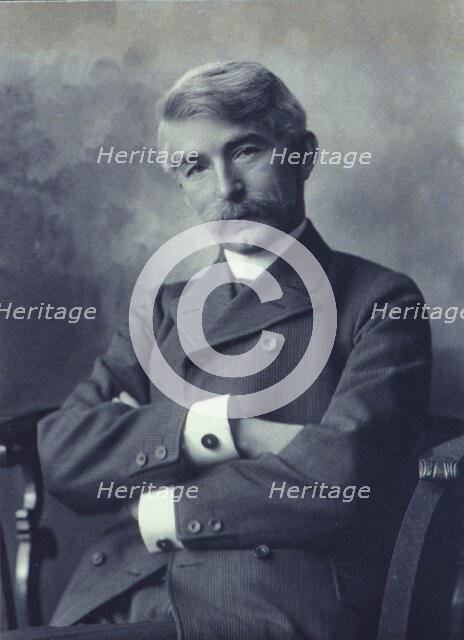 Portrait of man wearing a pinstripe suit seated with his arms crossed, c1900. Creator: Fannie L. Elton.
