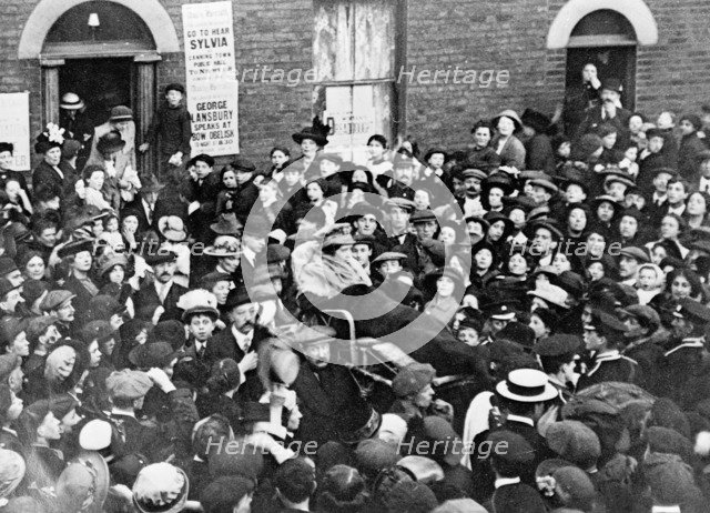 Sylvia Pankhurst leaving the East End of London in a bath-chair, June 1914. Artist: Unknown