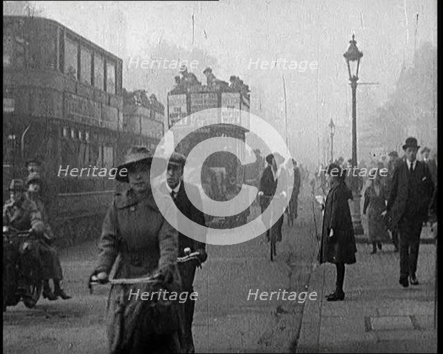 Traffic Scenes in London. Pedestrians, Cyclists, and Motorists All Passing By, 1922. Creator: British Pathe Ltd.