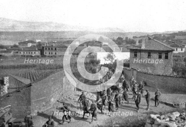 On the Eastern Front; Our Zouaves cross Pogradec, at the southern end of Lake Ohrid..., 1917. Creator: Unknown.