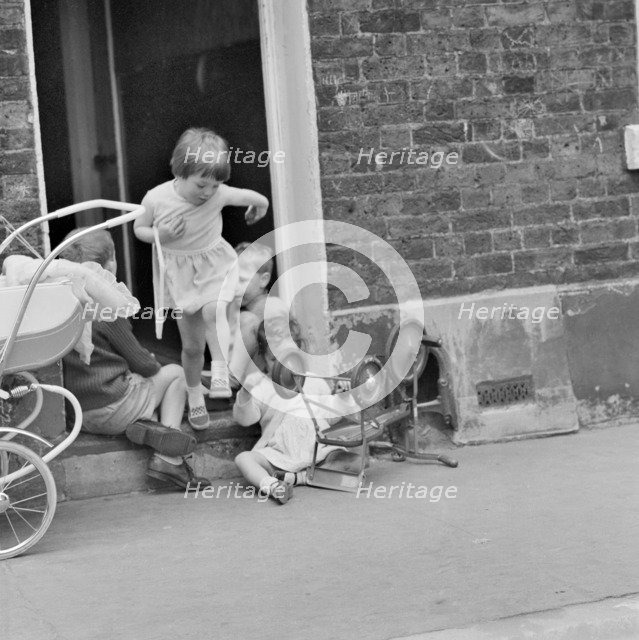 Children playing on a doorstep, London, 1960-1965. Artist: John Gay