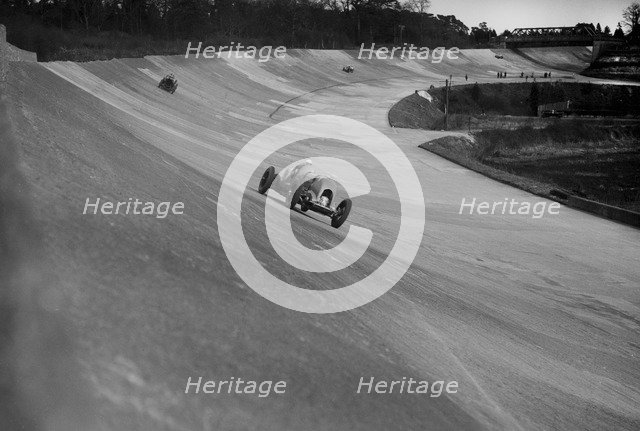 Bentley of Tim Birkin on the way to winning a race at a BARC meeting, Brooklands, 1930. Artist: Bill Brunell.