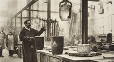Making money; pots of liquid metal being handled in the melting room, 20th century. Artist: Unknown