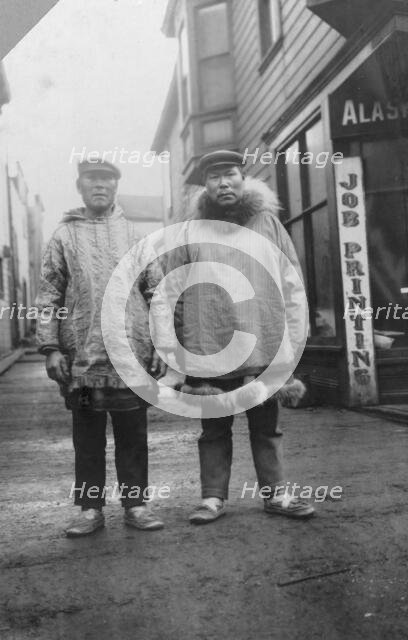 Eskimos outside shops, on a commercial street in Nome, between c1900 and 1916. Creator: Unknown.