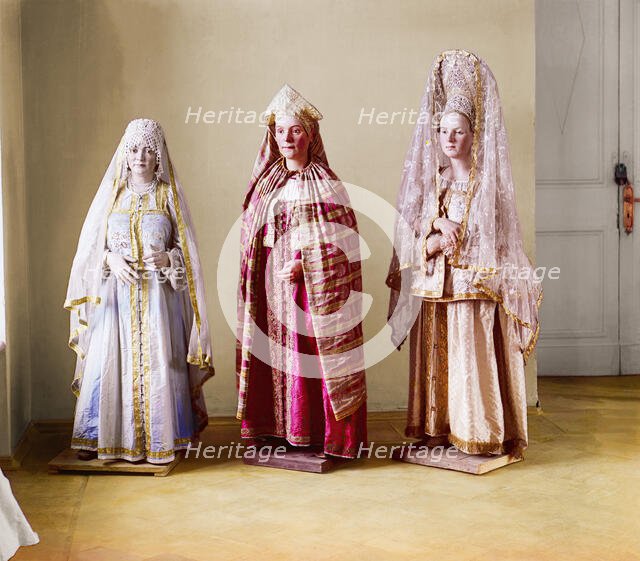 Three mannequins of women in elaborate dress, on wooden stands, between 1905 and 1915. Creator: Sergey Mikhaylovich Prokudin-Gorsky.