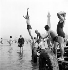 Children in swimming costumes jump into the sea, Blackpool, c1946-c1955. Artist: John Gay