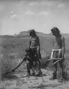 Me Sa Tawa catching snakes-Hopi, c1907. Creator: Edward Sheriff Curtis.
