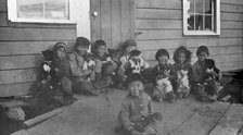 Eskimo children and puppies at the Moravian Mission Station, between c1900 and c1930. Creator: Unknown.