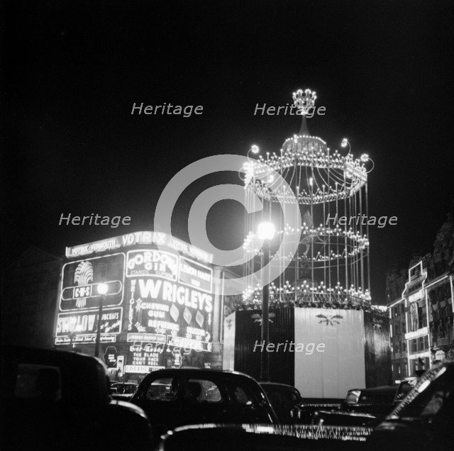 Night scene showing the neon lights of Piccadilly Circus, City of Westminster, c1945-c1965. Artist: SW Rawlings
