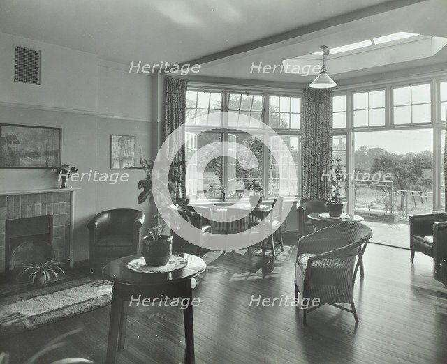 The sun lounge at Orchard House, Claybury Hospital, Woodford Bridge, London,1937. Artist: Unknown.