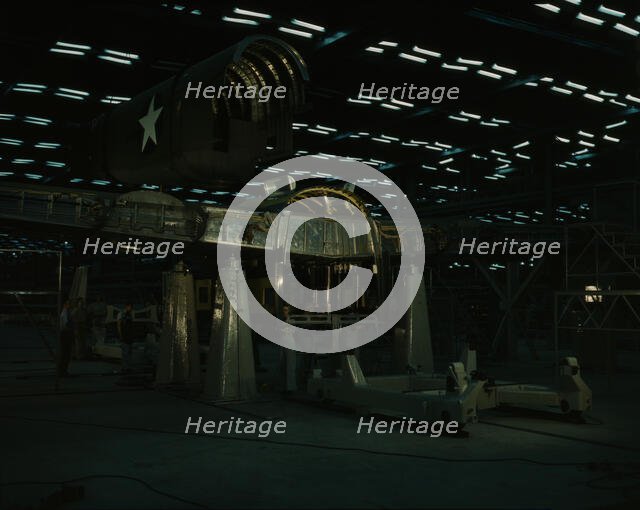 Fitting the tail of a transport plane to the wing...Consolidated Aircraft..., Fort Worth, TX, 1942. Creator: Howard Hollem.