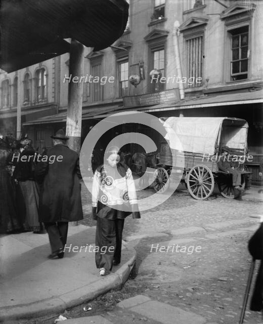 A woman in holiday attire, Chinatown, San Francisco, between 1896 and 1906. Creator: Arnold Genthe.